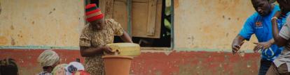 woman in uganda shows ceramic water filter